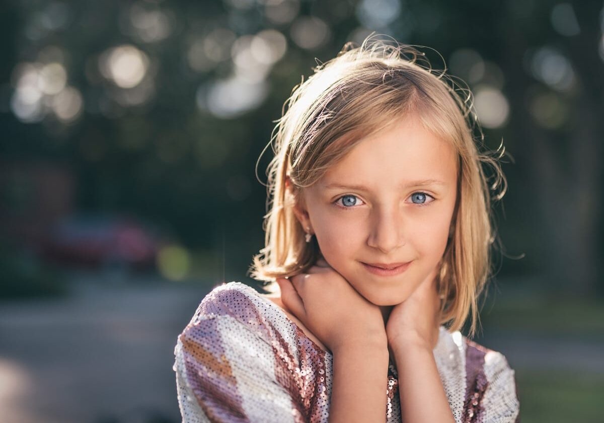 Young person looking thoughtfully toward the camera