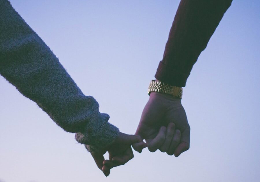 Two people holding hands