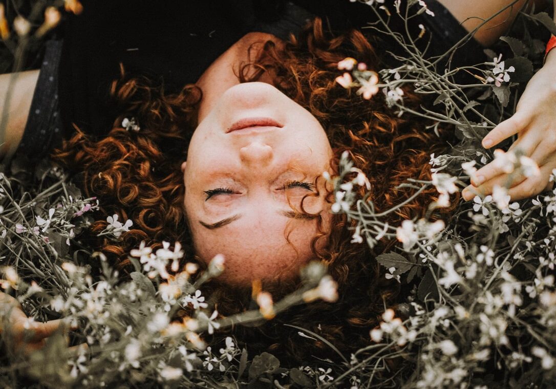 Person resting in a field of flowers