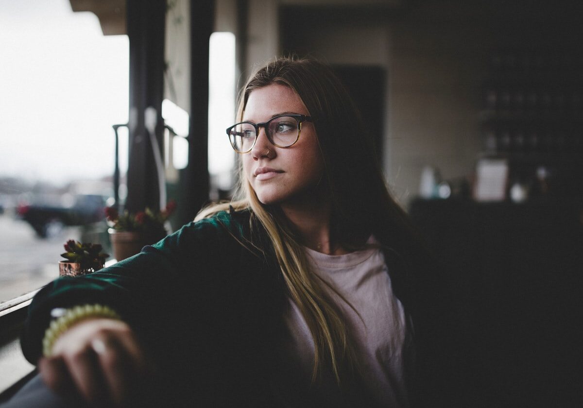 Person reflecting quietly outdoors